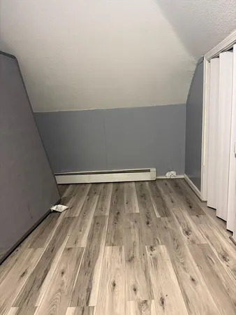 a view of a room with wooden floor