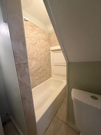 a bathroom with a bathtub and toilet