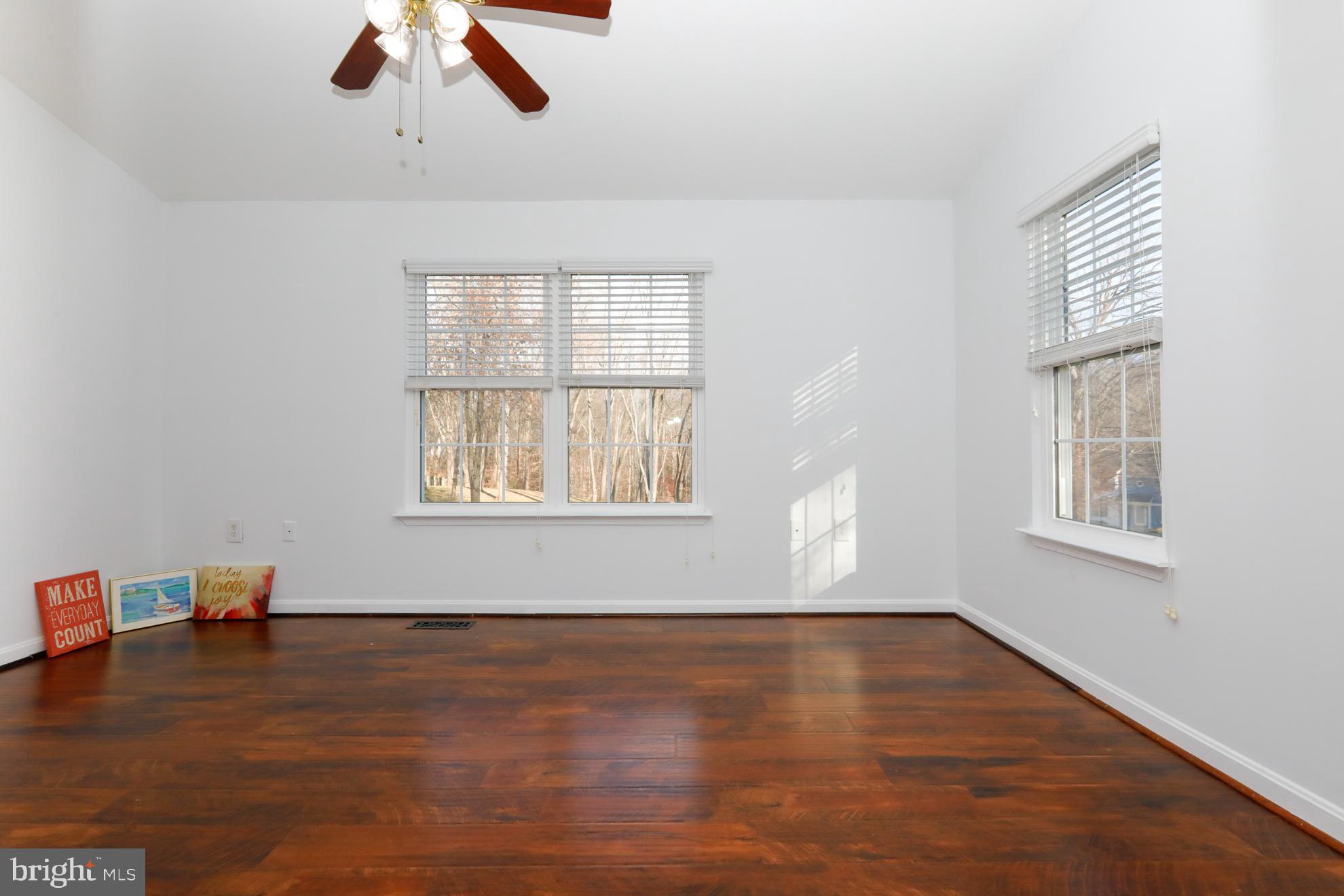 15334 Inlet Place Dumfries, VA 22025 - Photo 12 of 32 wooden floor in an empty room with a window