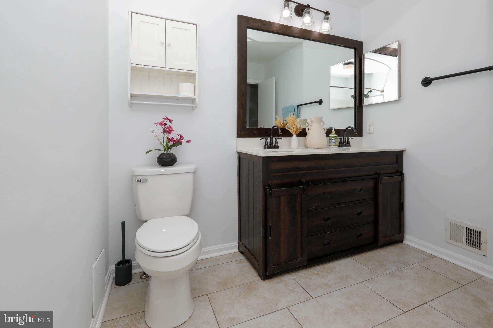 15334 Inlet Place Dumfries, VA 22025 - Photo 13 of 32 a bathroom with a toilet sink and mirror