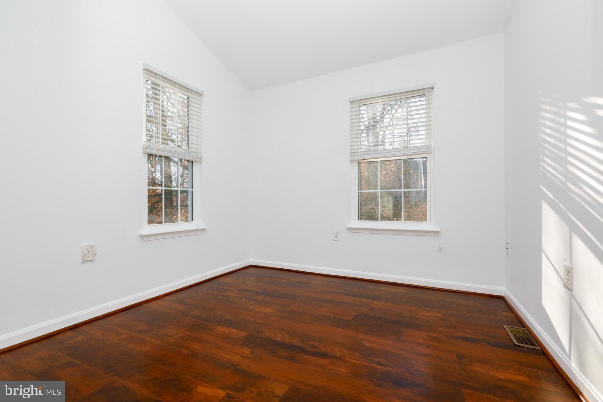15334 Inlet Place Dumfries, VA 22025 - Photo 17 of 32 an empty room with wooden floor and windows