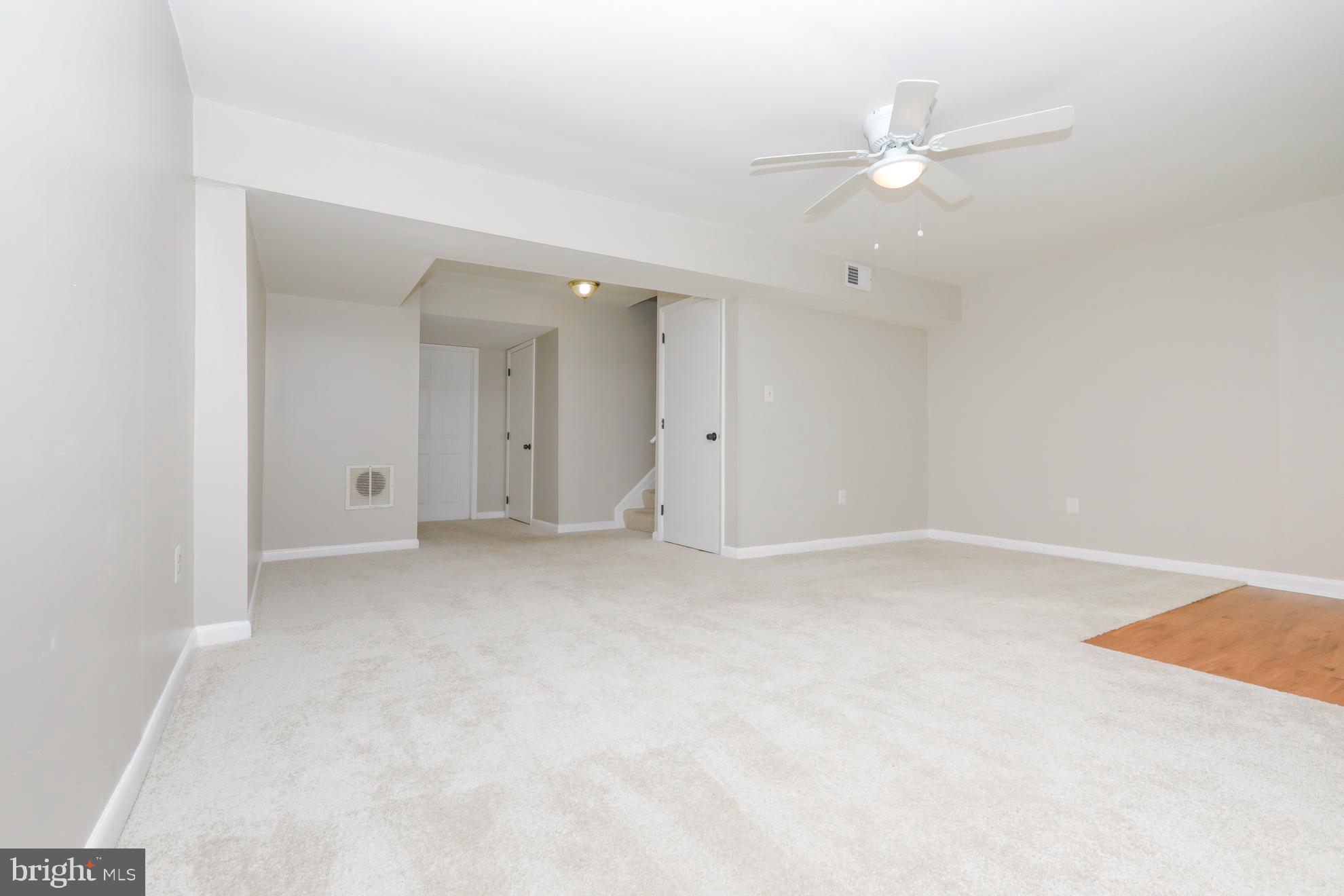 15334 Inlet Place Dumfries, VA 22025 - Photo 18 of 32 an empty room with a ceiling fan and window