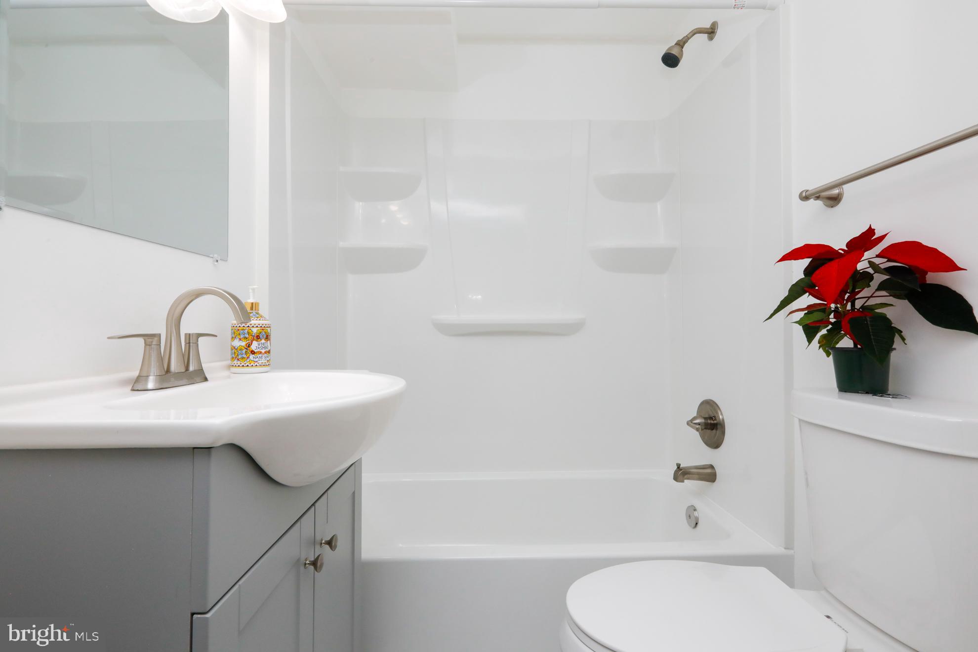 15334 Inlet Place Dumfries, VA 22025 - Photo 20 of 32 a bathroom with a sink toilet and shower