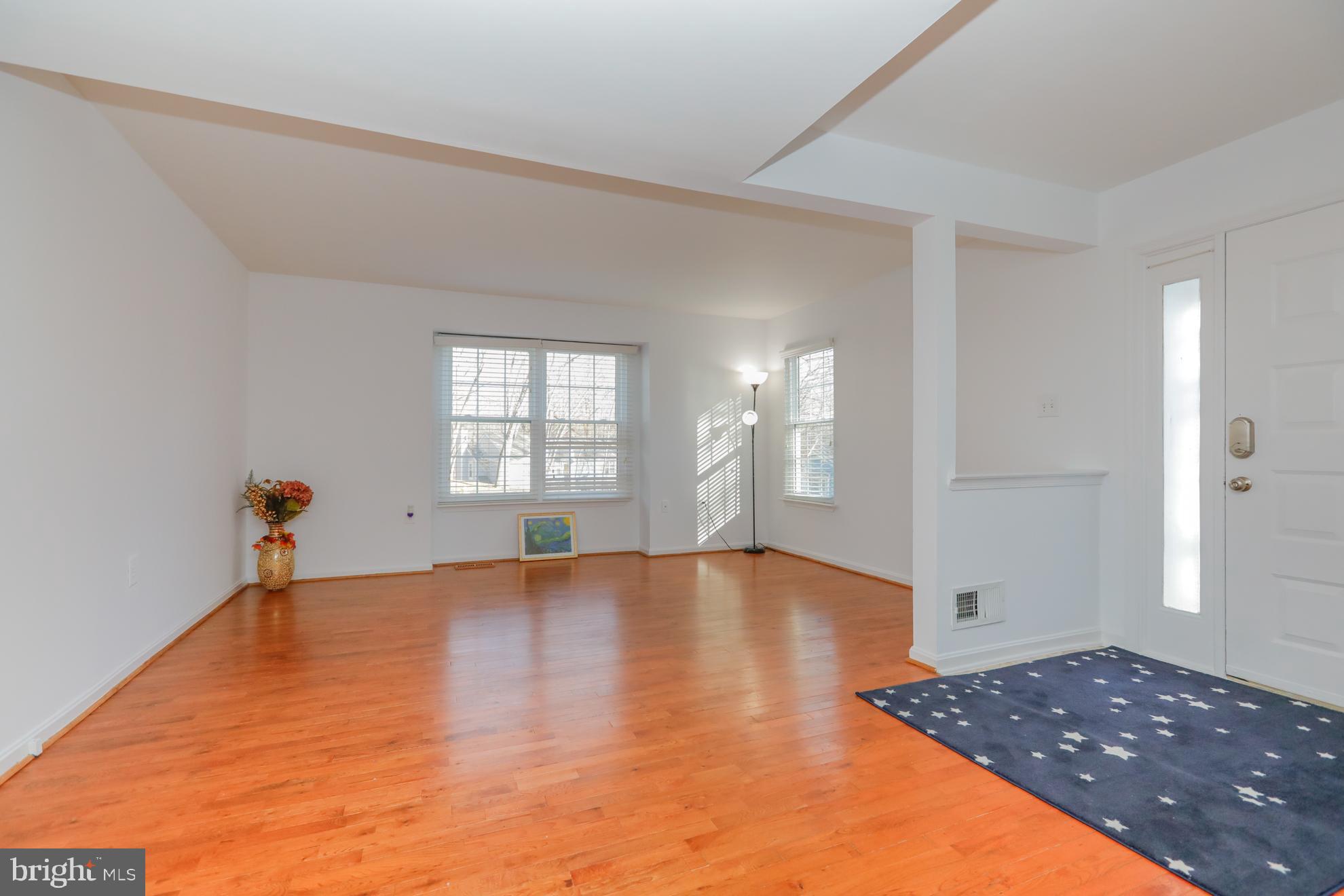 15334 Inlet Place Dumfries, VA 22025 - Photo 5 of 32 a view of an empty room with window and wooden floor