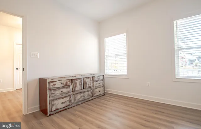 a kitchen with a sink cabinets and wooden floor