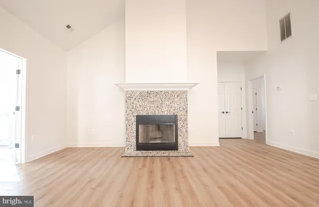 a kitchen with a sink cabinets and wooden floor