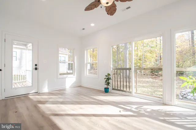 a bedroom with furniture and a large window