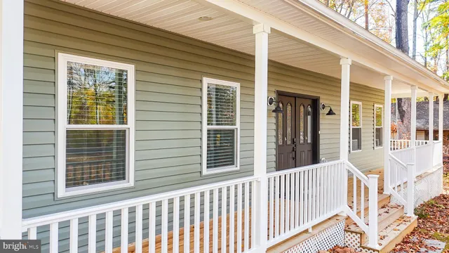 a view of a house with wooden fence