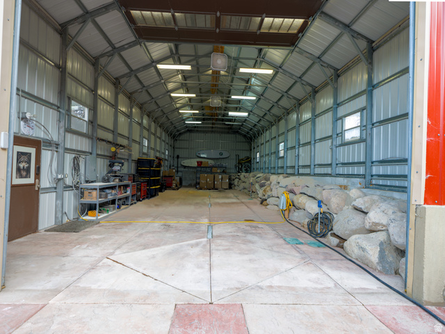 16535 South Redwood Road Riverton, UT 84065 - Photo 8 of 59 Large metal structure featuring a concrete floor, exposed metal framing, and multiple overhead lights