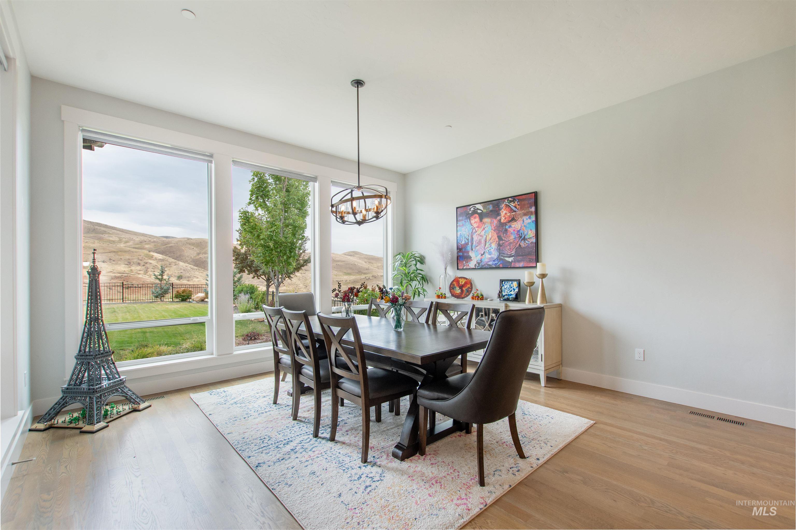2400 South Trapper Place Boise, ID 83716 - Photo 13 of 50 Dining room featuring a mountain view, light wood-type flooring, and a chandelier
