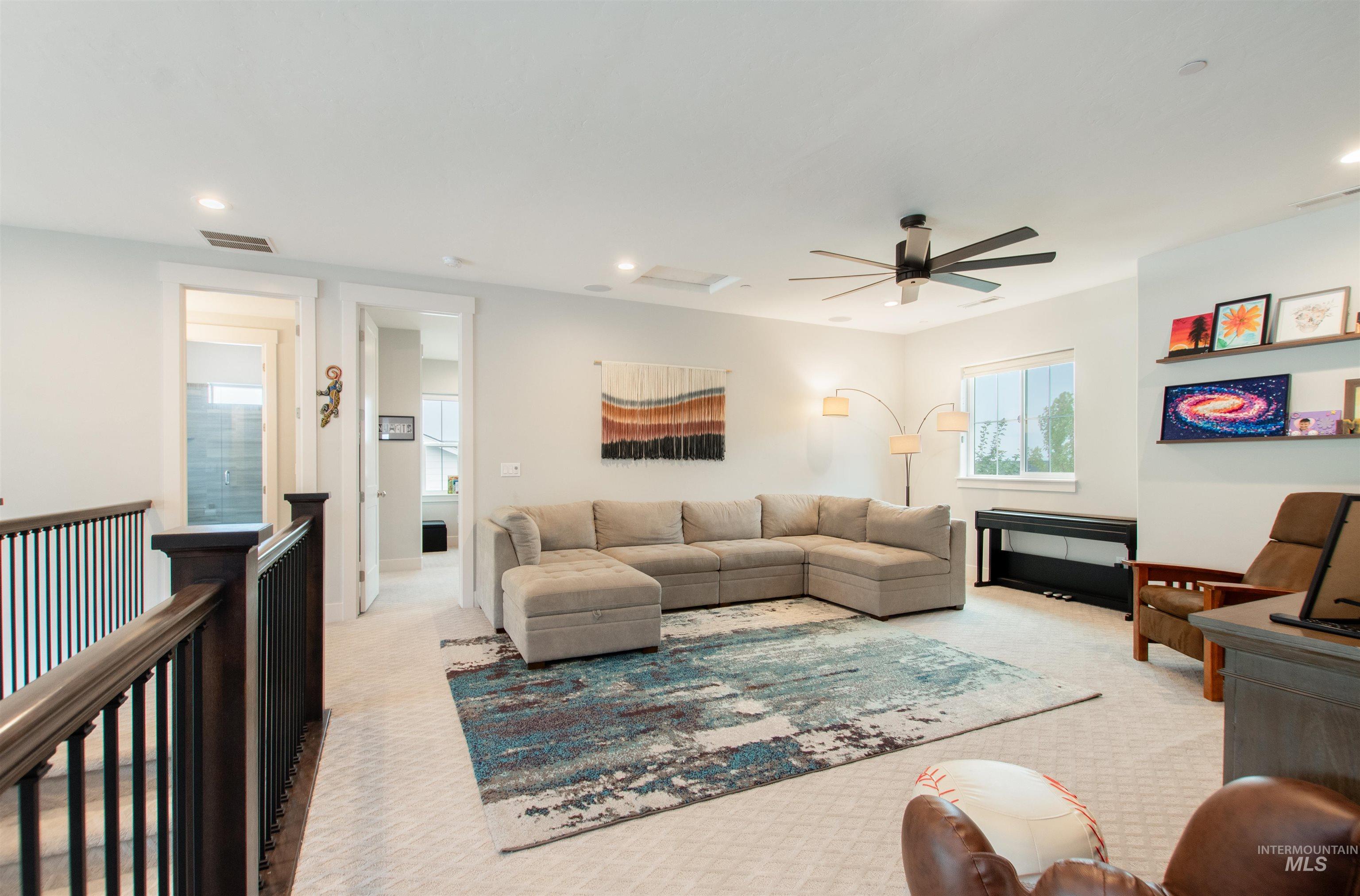 2400 South Trapper Place Boise, ID 83716 - Photo 23 of 50 Carpeted living area featuring recessed lighting, ceiling fan, and attic access
