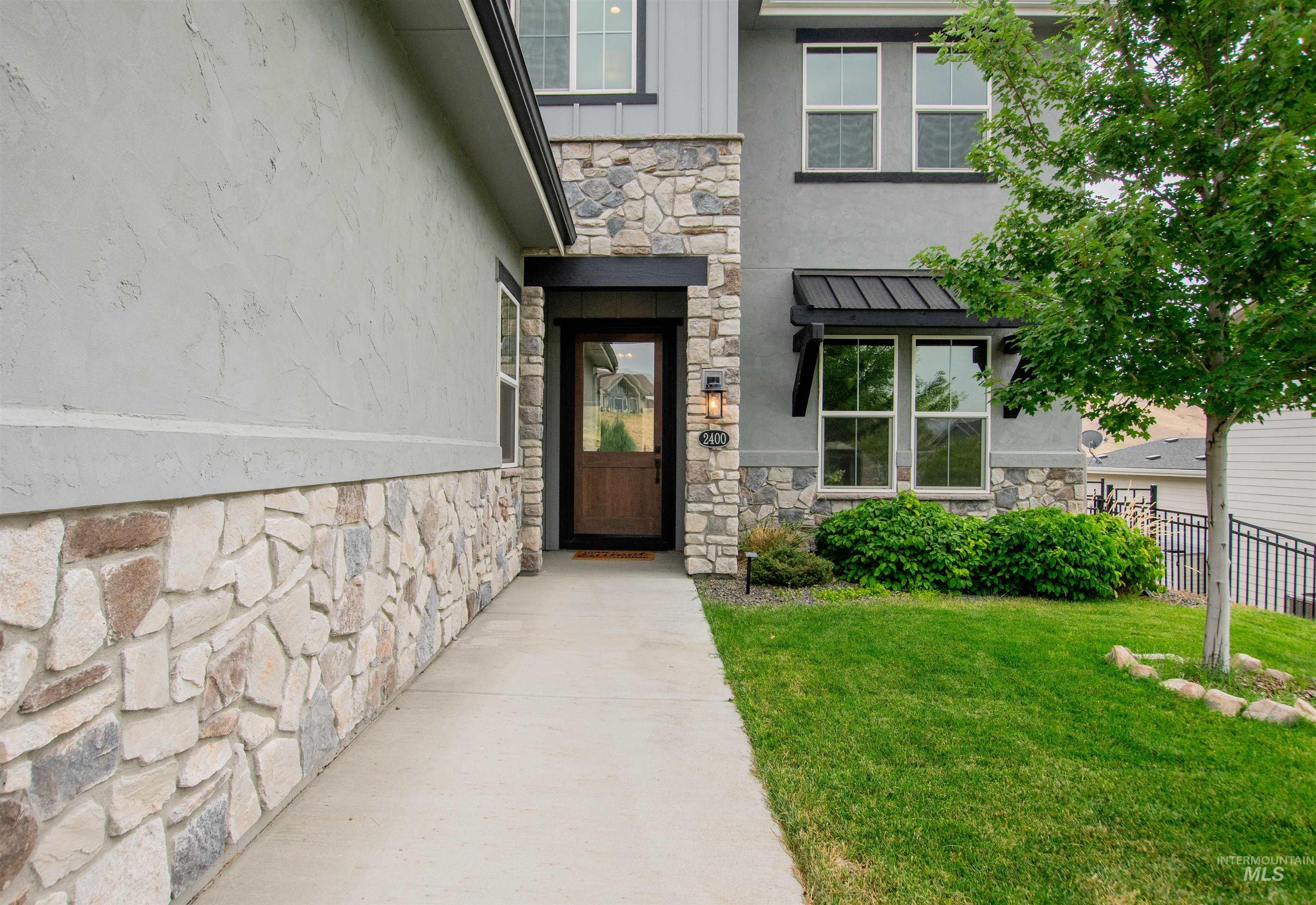 2400 South Trapper Place Boise, ID 83716 - Photo 4 of 50 Property entrance featuring stone siding and stucco siding