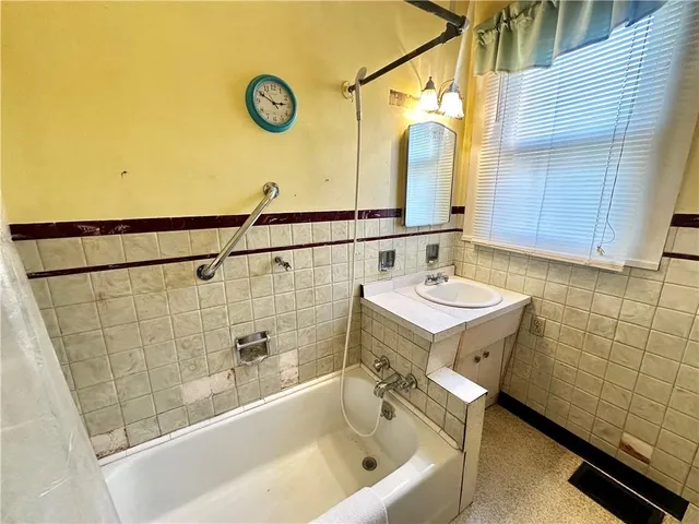 a bathroom with a sink a mirror and a bathtub