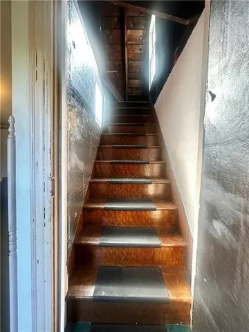 a view of a room with wooden floor and windows