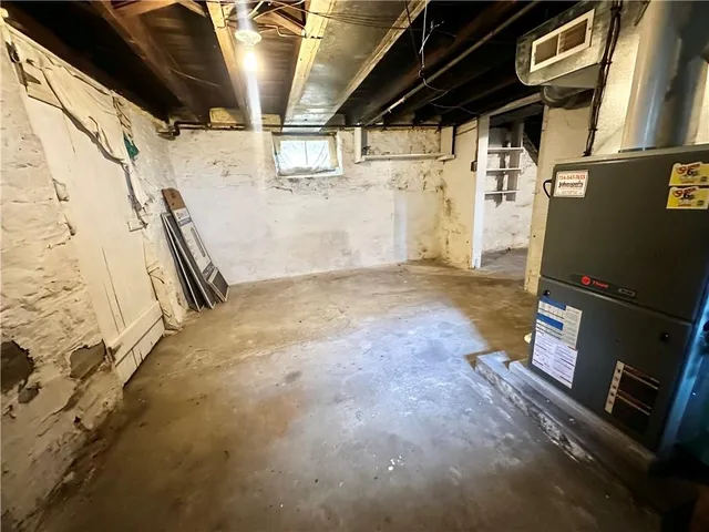 a view of a storage room with water heater and racks