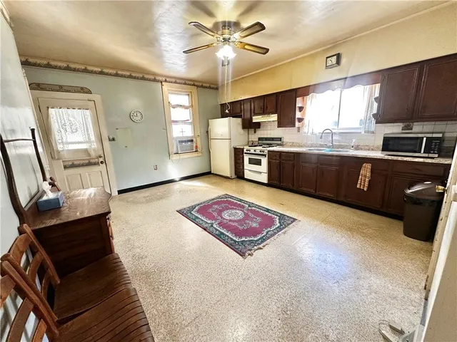 a kitchen with stainless steel appliances granite countertop a sink dishwasher stove and cabinets