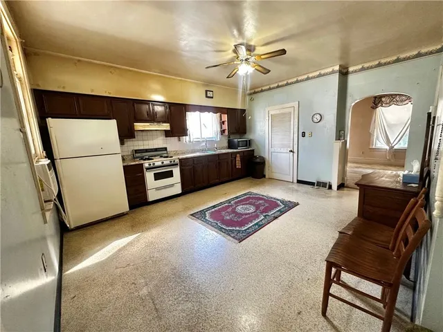 a open kitchen with sink refrigerator and stove