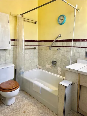 a bathroom with a sink mirror vanity and toilet