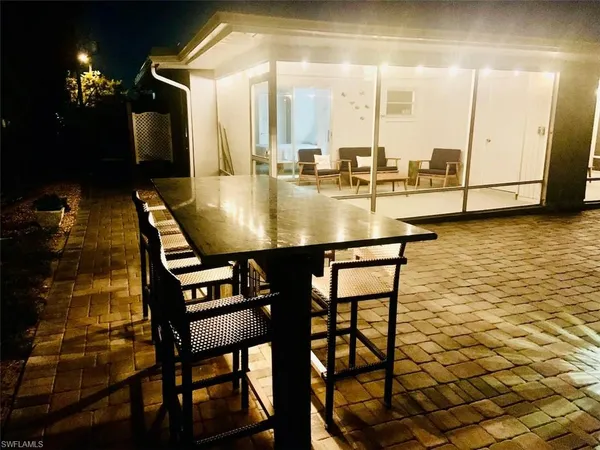 a view of a dining room with furniture and chandelier or bathroom