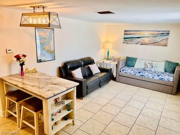 a living room with furniture and wall paintings