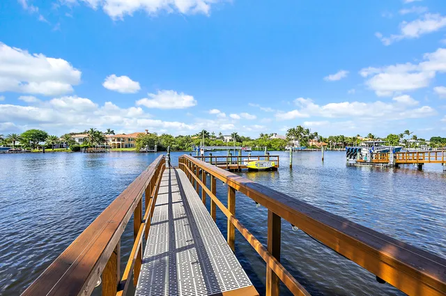 a large kitchen with stainless steel appliances lots of counter space and windows