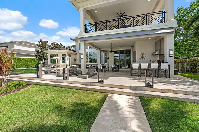 a living room with furniture a chandelier and a dining table