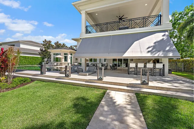 a living room with furniture a rug and a chandelier