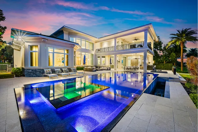 a view of spacious bathroom with a toilet sink and mirror