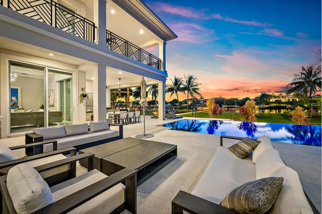 a living room with furniture kitchen view and a potted plant
