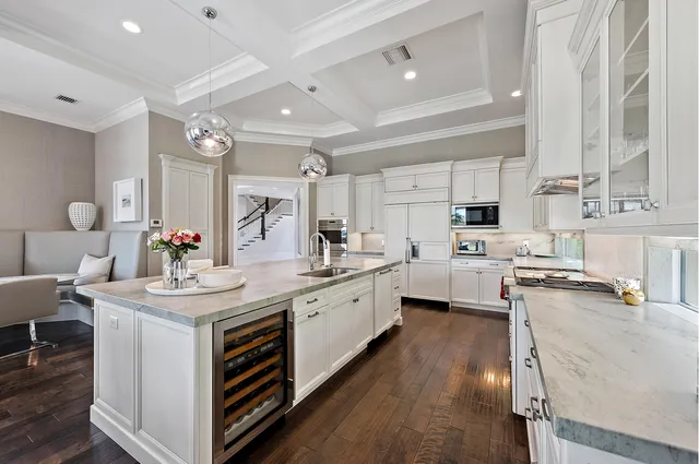 a bathroom with a granite countertop sink toilet a large mirror a shower and a glass door