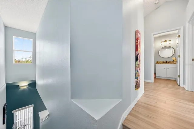 a view of a hallway with wooden floor