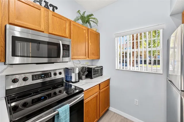 a kitchen with stainless steel appliances a stove a microwave and cabinets