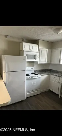 a kitchen with a refrigerator and a more window