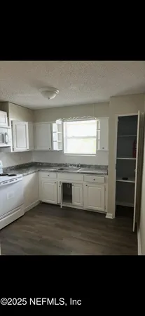 a view of a kitchen with a sink