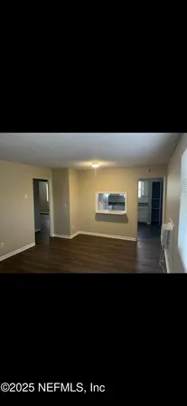 a view of room with wooden floor