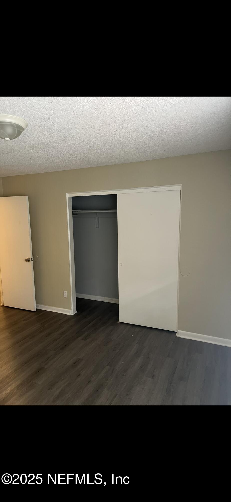 1110 Caliente Drive, Unit 52 Jacksonville, FL 32211 - Photo 8 of 12 a view of an empty room with wooden floor