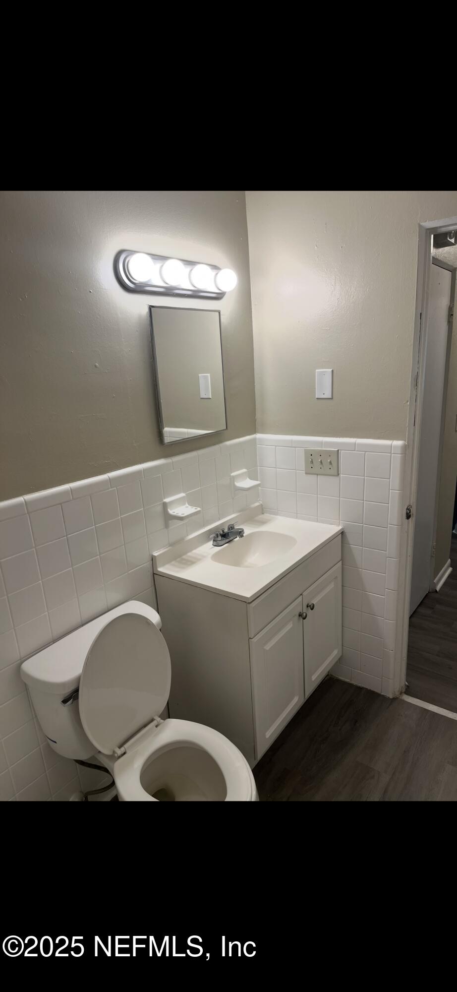 1110 Caliente Drive, Unit 52 Jacksonville, FL 32211 - Photo 10 of 12 a bathroom with a sink a toilet and mirror