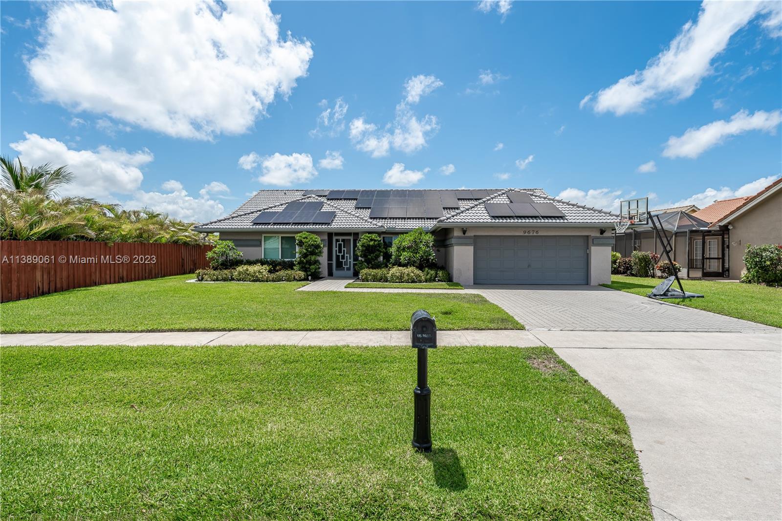 9676 El Clair Ranch Road Boynton Beach, FL 33437 - Photo 30 of 35 a front view of a house with a yard