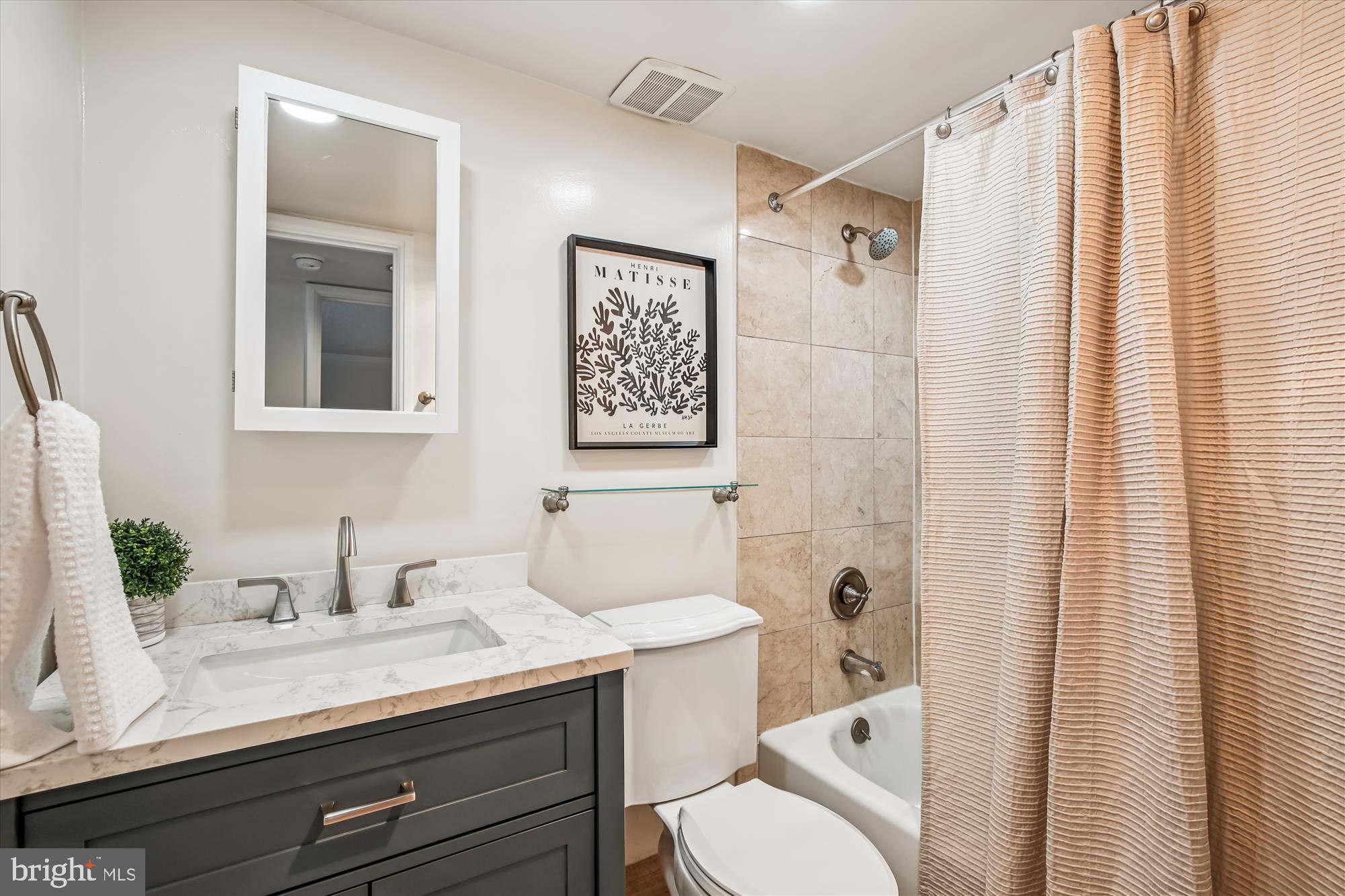 1077 30th Street Northwest, Unit 612 Washington, DC 20007 - Photo 24 of 44 a bathroom with a granite countertop sink a toilet and shower