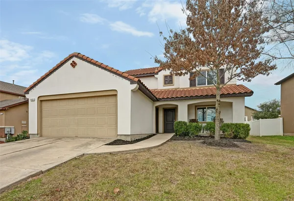 a front view of a house with a yard and garage
