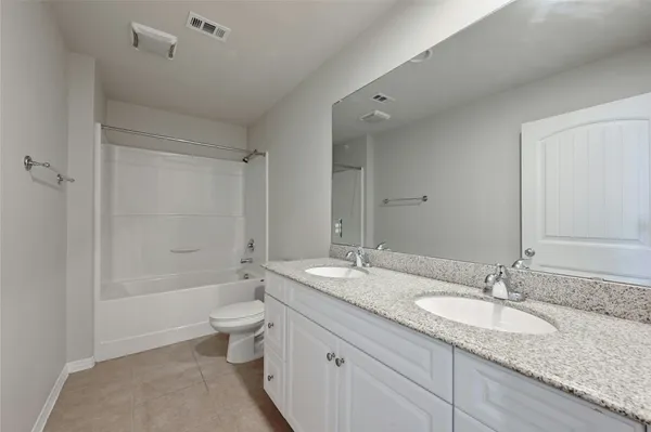 an empty room with a window and ceiling fan