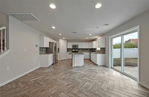 a view of a kitchen with a sink and cabinets