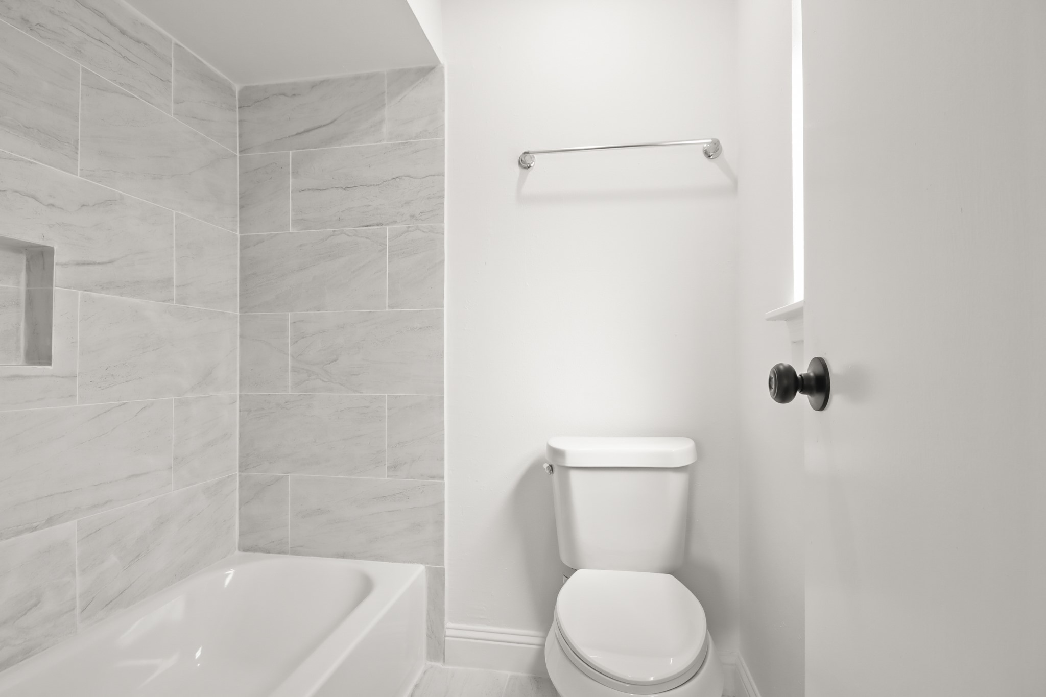 24127 Spring Fork Drive Spring, TX 77373 - Photo 12 of 17 A beautifully refreshed bath features sleek tilework and a full tub-and-shower combination designed for both relaxation and practicality.