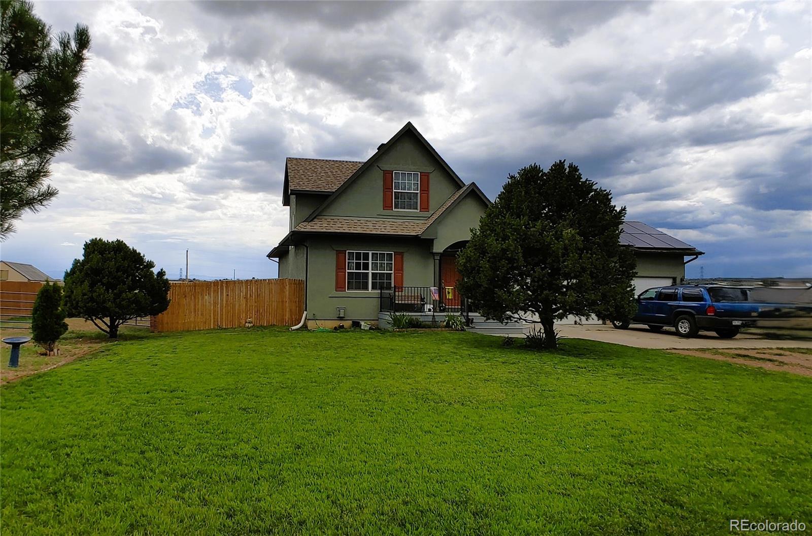 1451 Challenger Drive Pueblo West, CO 81007 - Photo 17 of 26 a front view of a house with garden