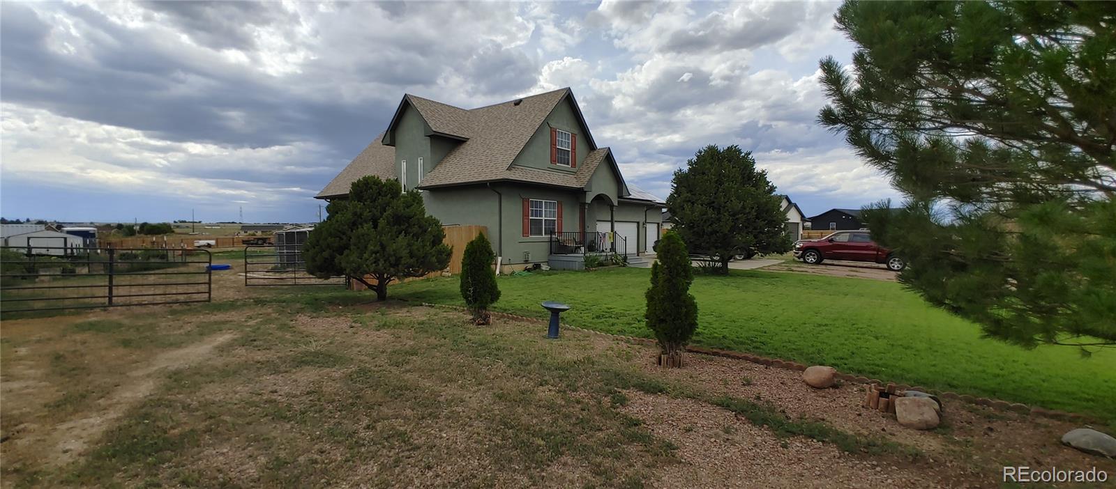 1451 Challenger Drive Pueblo West, CO 81007 - Photo 19 of 26 a view of a house with a yard