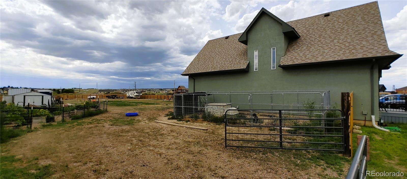 1451 Challenger Drive Pueblo West, CO 81007 - Photo 20 of 26 a view of a street with wooden fence
