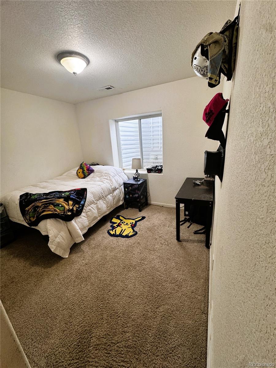 1451 Challenger Drive Pueblo West, CO 81007 - Photo 4 of 26 a room with furniture and a window