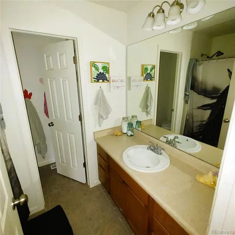 a bathroom with a sink a tub and a mirror