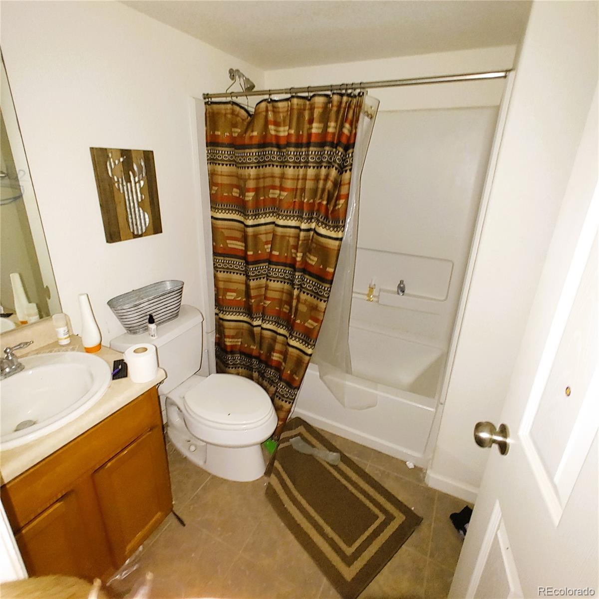 1451 Challenger Drive Pueblo West, CO 81007 - Photo 9 of 26 a bathroom with a toilet and a shower