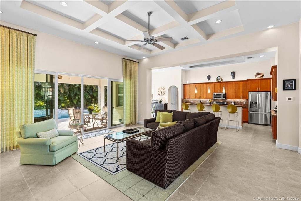 4940 Southeast Inlet Isle Way Stuart, FL 34997 - Photo 12 of 75 a living room with furniture and a large window